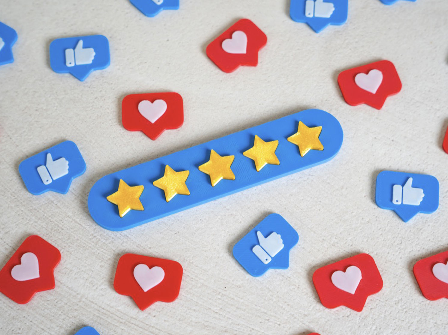 Five gold stars on a blue rounded bar surrounded by blue like icons and red heart icons (social media rating).] ,