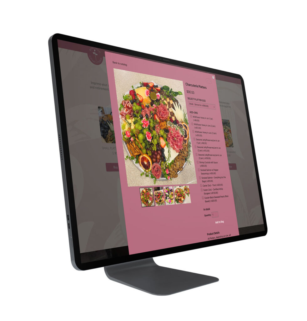 A desktop computer displaying an e-commerce product page for "Charcuterie Platters" featuring a large photo of a platter along with custom add-on ordering options.