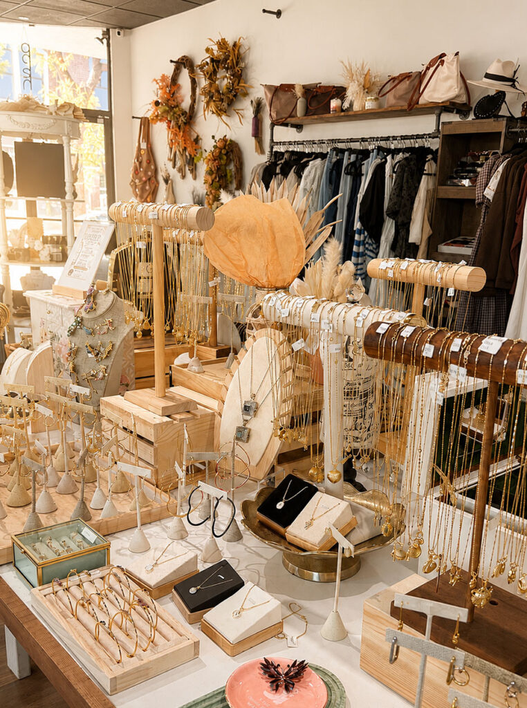 Jewelry, handbags, clothing, and handmade accessories displayed inside Rustic & Modern Collective in Downtown Upland.