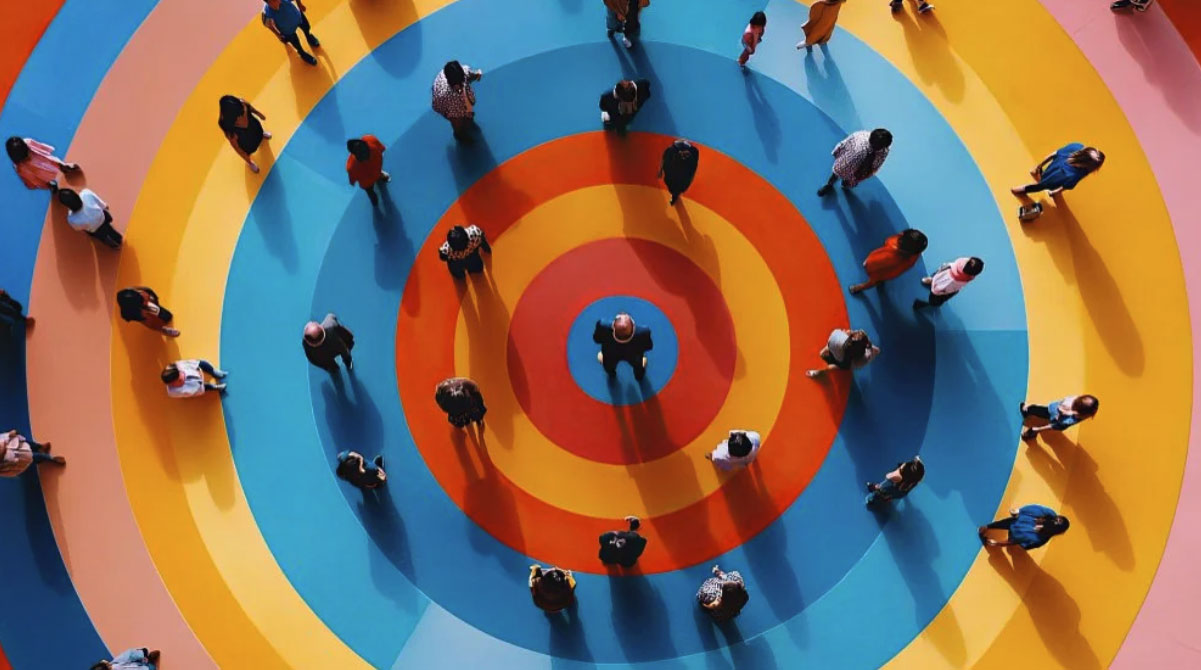 People standing on a colorful target representing small business target audience marketing
